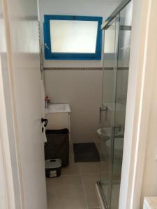 a bathroom with a glass shower and a sink at Grazioso Monolocale ristrutturato a due passi dal mare in Marotta