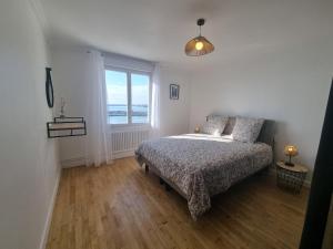 a bedroom with a bed and a large window at House for 4 people with a breathtaking view in Plérin