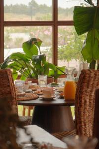 a table with food and a glass pitcher of orange juice at Quinta Amarela - B&B in Nazaré +34 photos