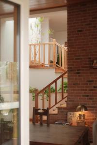 a room with a wooden staircase with a wooden table at Quinta Amarela - B&B in Nazaré