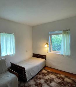 a bedroom with a bed and a window at Під рідним небом in Balyko-Shchuchinka