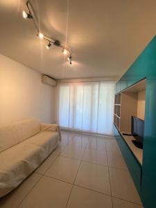 een woonkamer met een bank en een televisie bij Bilocale Le Furama in Antibes +6 foto's