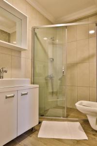 a bathroom with a shower and a sink and a toilet at Orya Butik Otel in Side +19 photos