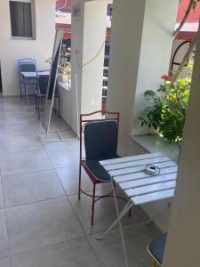 a room with chairs and a table and a table and chairs at LAVİNYA PENSİON in Kusadası