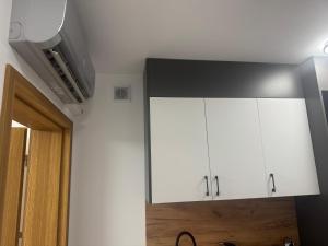 a kitchen with white cabinets in a room at Apartament City Łuków in Łuków +9 photos