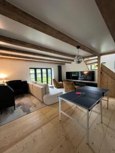 a living room with a white couch and a table at Black House Pärnu in Pärnu