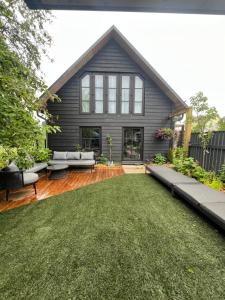 a house with a large backyard with a lawn at Black House Pärnu in Pärnu