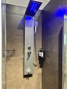 a bathroom with a shower with a shower head at Cadriano House 