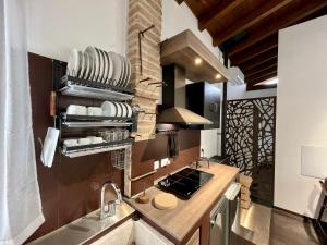 a kitchen with a sink and a stove top oven at Cadriano House in Granarolo dellʼEmilia