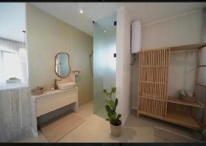 a bathroom with a sink and a mirror at Frida en suite in Sukošan
