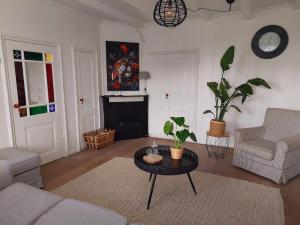 a living room with a couch and a table at Boerderij Blok in Barsingerhorn