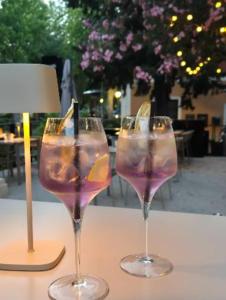 three wine glasses sitting on a table next to a lamp at Apartma Izola in Izola