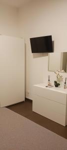 a kitchen with white cabinets and a black microwave at Casa Camillo via Camillo Benso di Cavour n 63bis in Avola