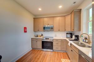 a kitchen with wooden cabinets and stainless steel appliances at Loft vibes at the city Barn in Spartanburg