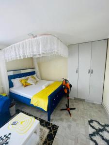 a bedroom with a bed with a canopy at Tausi Studio Greenspot in Ruiru