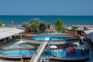 two swimming pools with the ocean in the background at White Titanic 204 in Mamaia Sat/Năvodari