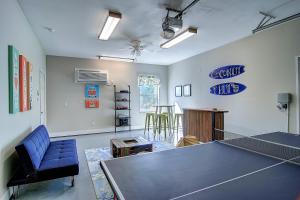a living room with a ping pong table in it at Coconut Hut - Pet Friendly! Boardwalk to the Beach! - Pet Friendly! Boardwalk to the Beach! in Mustang Beach