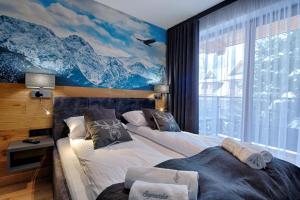 Posteľ alebo postele v izbe v ubytovaní Apartamenty Koziniec