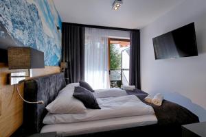 Posteľ alebo postele v izbe v ubytovaní Apartamenty Koziniec