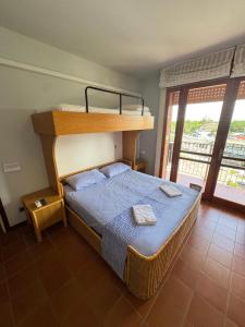 a bedroom with a bunk bed and a balcony at Ampio appartamento in centro con vista - terrazze, parcheggio gratuito e Wi-Fi in Lignano Sabbiadoro