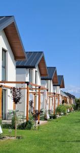 a row of houses with solar panels on them at Chillera Domki in Łeba