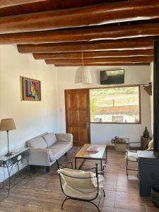 a living room with a couch and a table at Cabañas La Nochera in Tilcara +47 photos