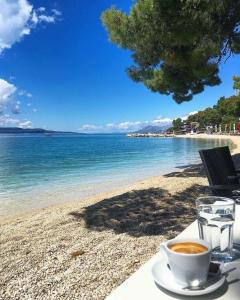 a cup of coffee sitting on a table on a beach at Gajeta in Betina