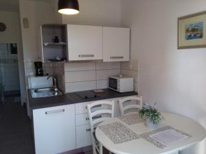 a small kitchen with a table and a microwave at Gajeta in Betina
