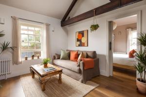 a living room with a couch and a bed at Leworth Apartments, Windsor in Windsor +15 photos