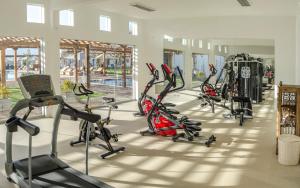 a gym with a row of exercise bikes and treadms at Hotel Viñas Queirolo in Ica