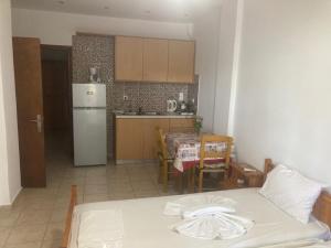 a kitchen and a table with a bed in a room at Liberty-Studio N1 in Georgioupolis