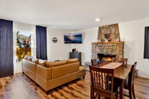 a living room with a couch and a table and a fireplace at The weekender #2342 in Big Bear City