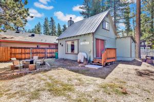 a tiny house in a yard next to a fence at The weekender #2342 in Big Bear City