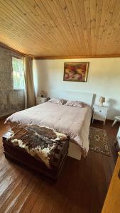 a bedroom with a large bed with a wooden ceiling at Casa da Poça in Baião +31 photos