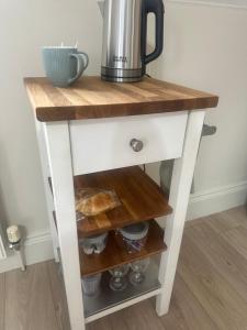 a kitchen island with a wooden counter top and a drawer at Roe Valley Getaway in Limavady +5 photos