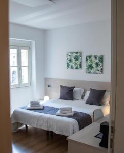 Postel nebo postele na pokoji v ubytování Conte Durini Apartments & Rooms