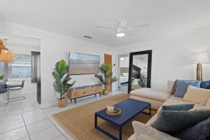 a living room with a couch and a table at Smyrna Sol in New Smyrna Beach