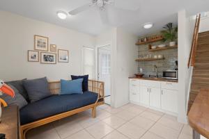 a living room with a couch and a kitchen at Smyrna Sol in New Smyrna Beach