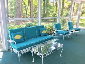 a porch with blue furniture and a glass coffee table at Rolling road 38 in Rehoboth Beach