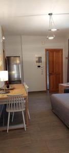 a room with a table and a bed and a desk at Ammophila-Lemnos 3 in Mirina +11 photos