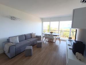 a living room with a couch and a table at couché de soleil in Patrimonio