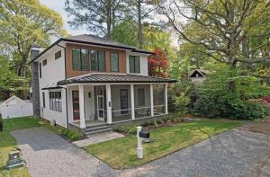 a small white house with a porch on a yard at Columbia avenue 48 in Rehoboth Beach