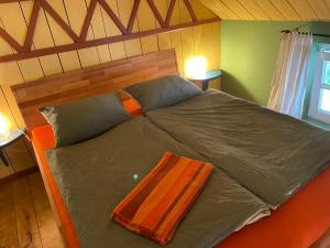 a large bed with a wooden headboard in a room at Badehaus Villa Fiedrichs in Ilmenau