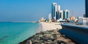 a view of a beach with buildings and the ocean at Zaza home in Ajman 