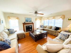 a living room filled with furniture and a fireplace at Anchor road 57 in Rehoboth Beach