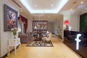 a living room with a couch and a tv at F Hotel Jakarta in Jakarta