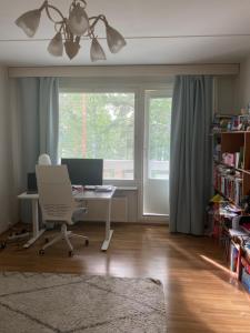 an office with a desk and a chair and a window at Huhtiniemenranta in Lappeenranta