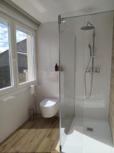 a bathroom with a glass shower and a toilet at A Academia in Vimianzo +34 photos