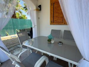 a table and chairs on a patio with a window at vera home shine in Vera