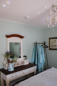 a bedroom with a vanity with a mirror and a bed at Lime cottage in Kilrush
